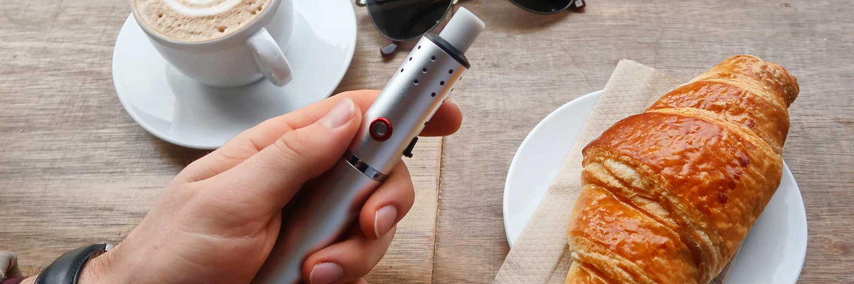 Vaping with a dry herb vaporizer in a cafe